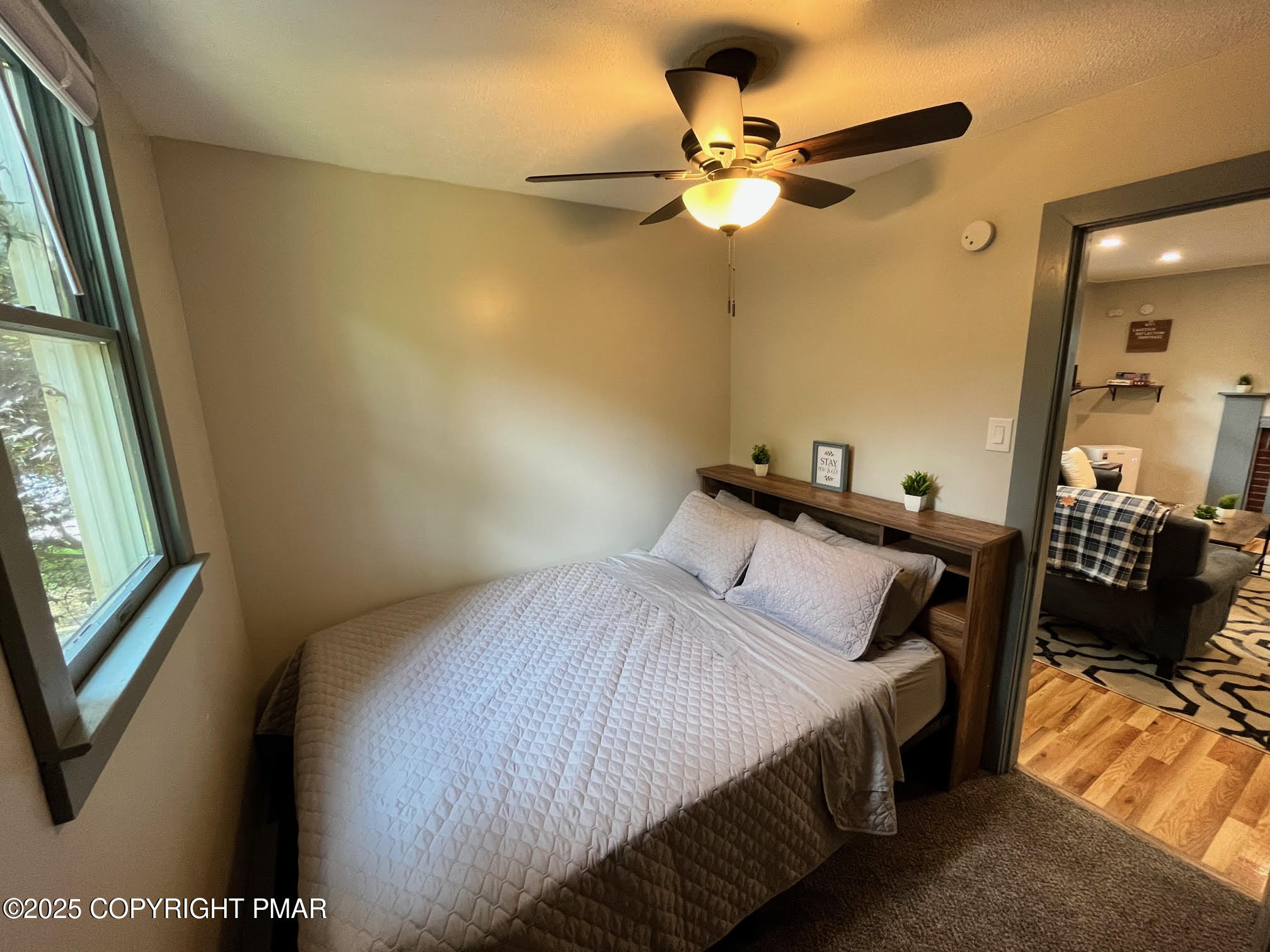 4 1st Street Hawley, PA 18428 - Photo 16 of 32 a bedroom with a bed a window and a chandelier