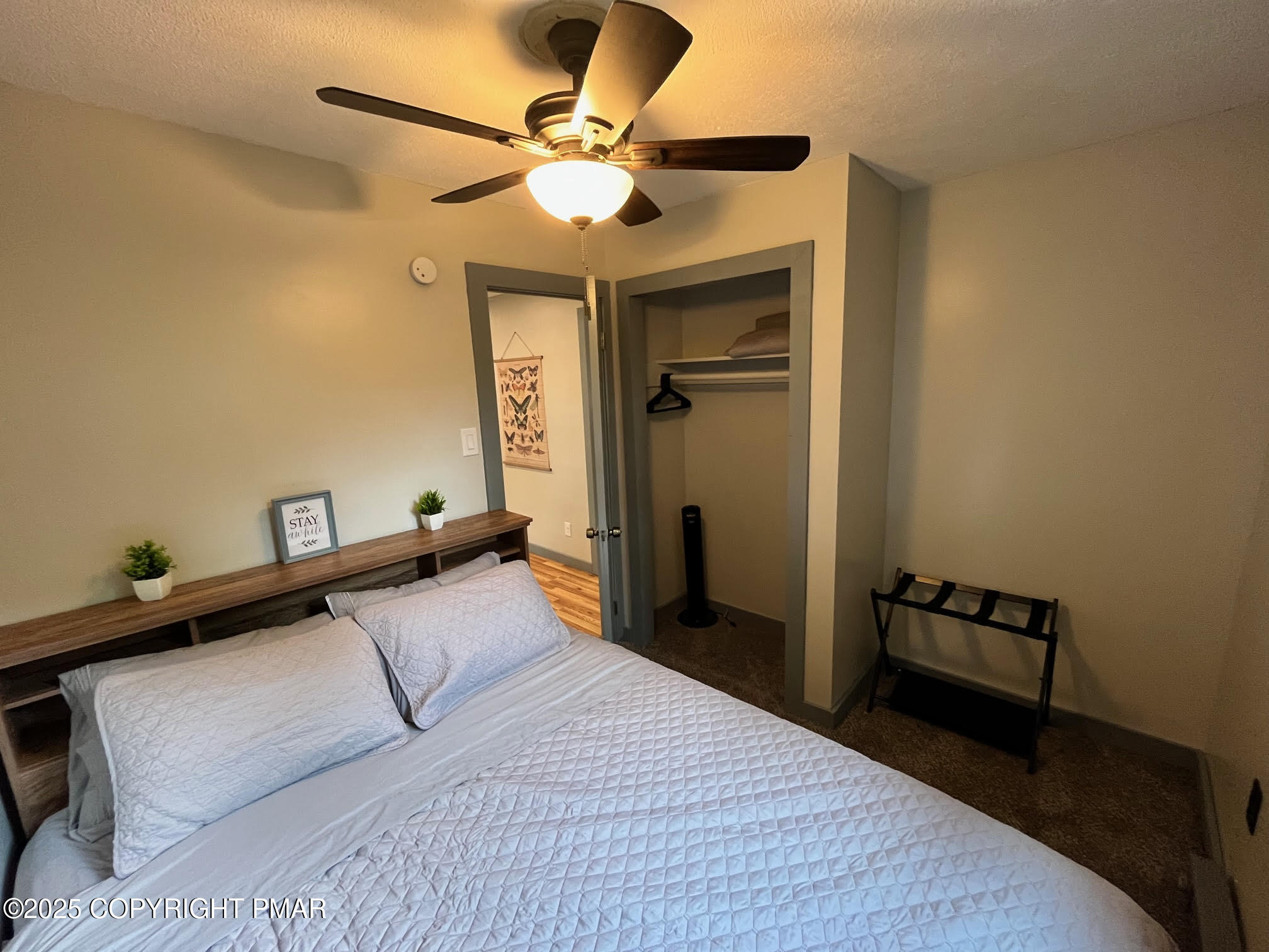 4 1st Street Hawley, PA 18428 - Photo 17 of 32 a bedroom with a bed and a chandelier