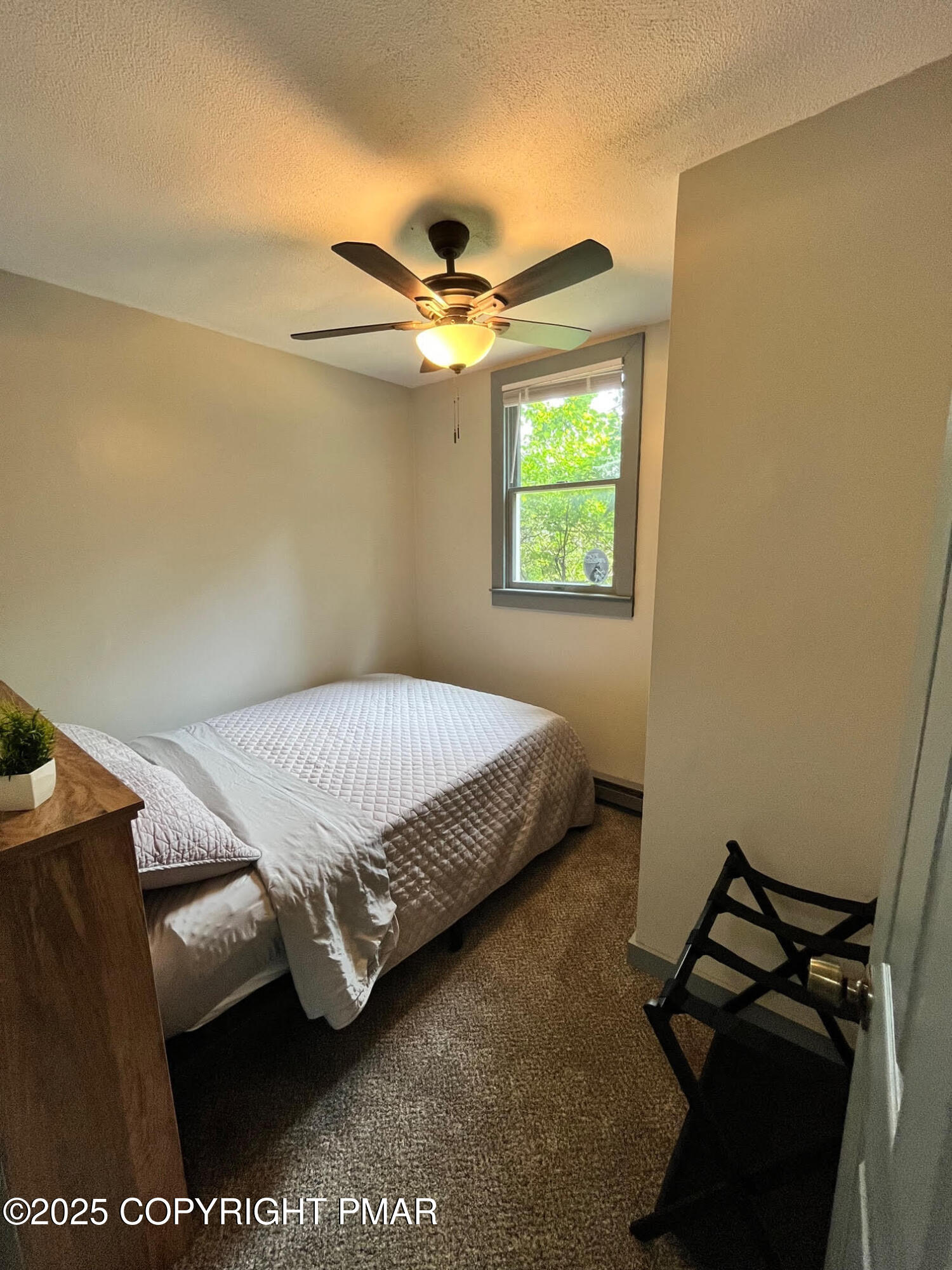 4 1st Street Hawley, PA 18428 - Photo 20 of 32 a bedroom with a bed and a chandelier