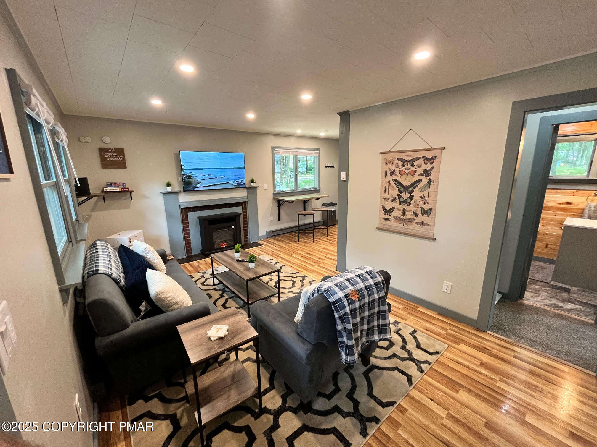 4 1st Street Hawley, PA 18428 - Photo 28 of 32 a living room with furniture a fireplace and wooden floor