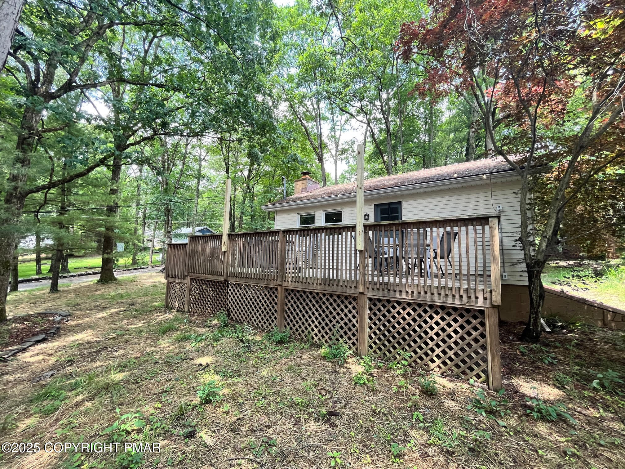 4 1st Street Hawley, PA 18428 - Photo 6 of 32 a view of a house with a wooden deck and trees