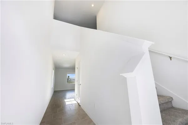 a view of a hallway with stairs