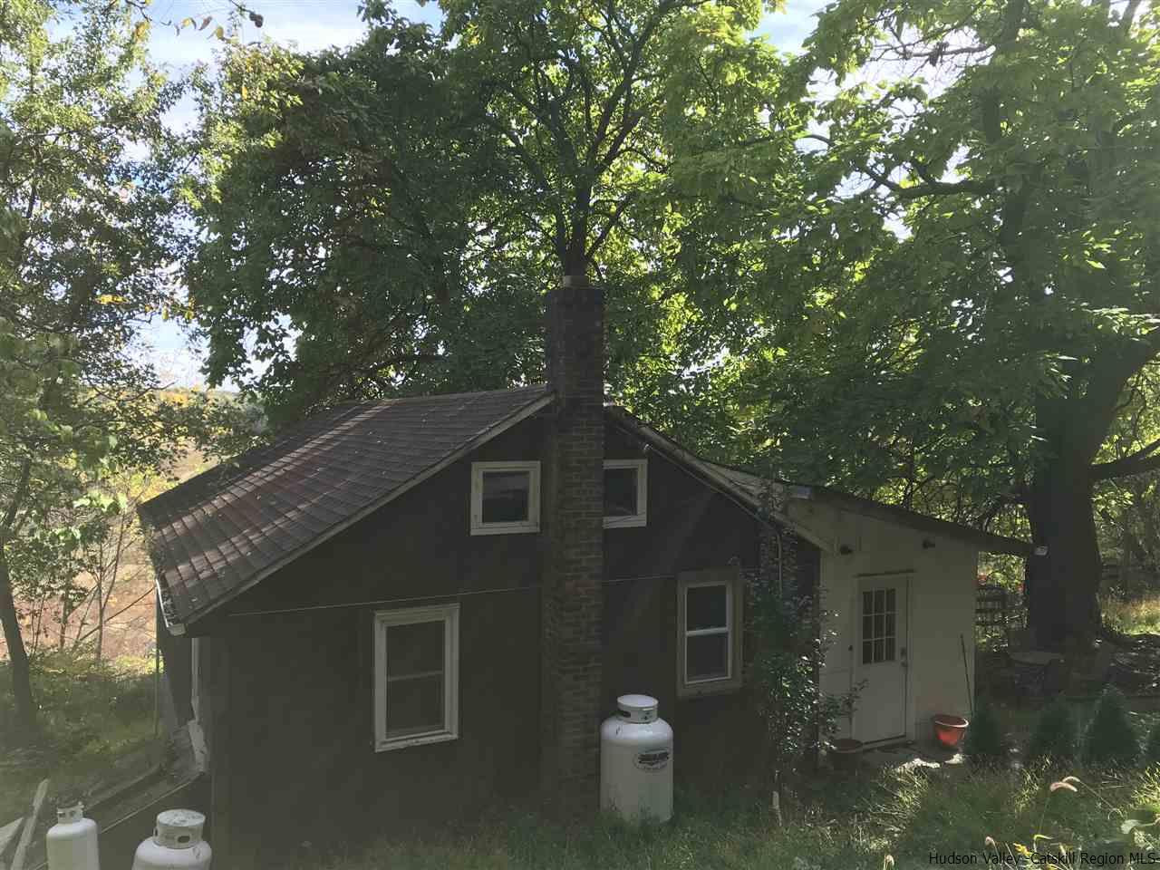 163 Churchland Road Saugerties, NY 12477 - Photo 1 of 20 a front view of a house with a tree