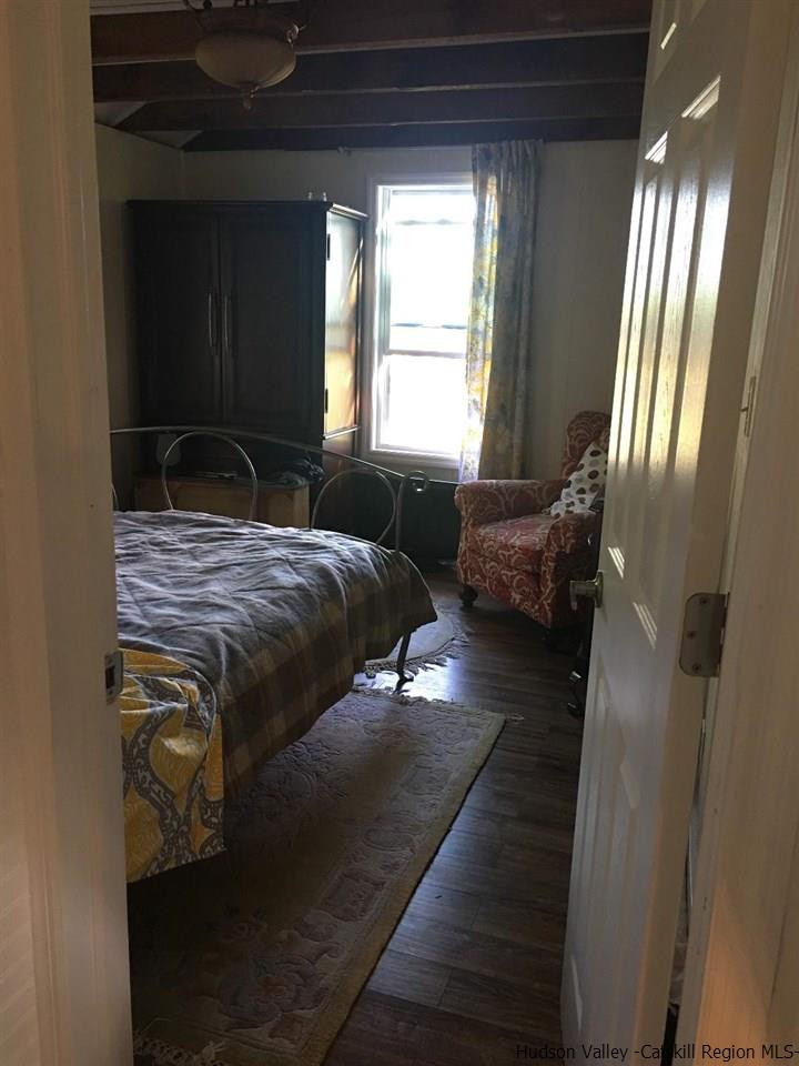 163 Churchland Road Saugerties, NY 12477 - Photo 12 of 20 a bedroom with a bed and wooden floor