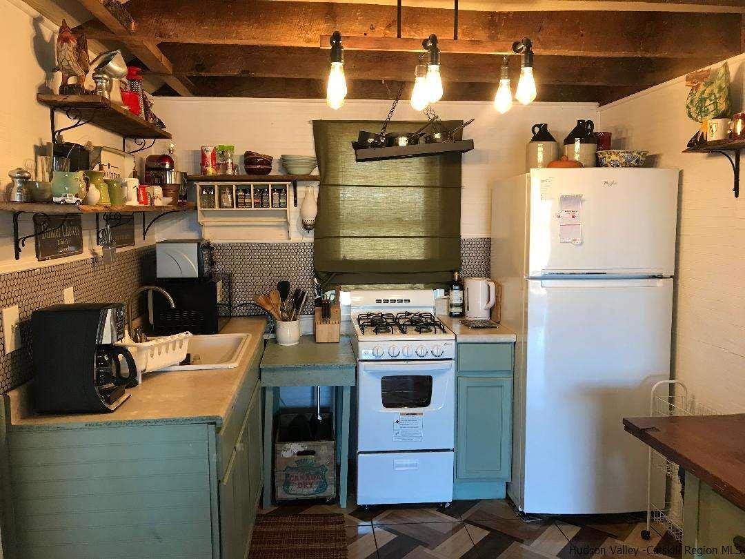 163 Churchland Road Saugerties, NY 12477 - Photo 2 of 20 a kitchen with a refrigerator and a stove