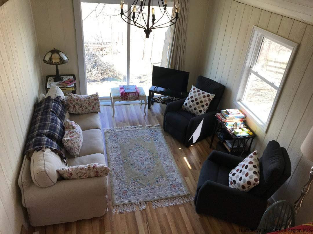 163 Churchland Road Saugerties, NY 12477 - Photo 4 of 20 a living room with furniture and a large window