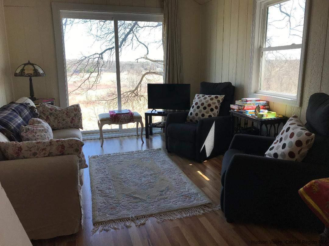163 Churchland Road Saugerties, NY 12477 - Photo 6 of 20 a living room with furniture and a large window