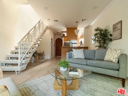 a living room with furniture and wooden floor