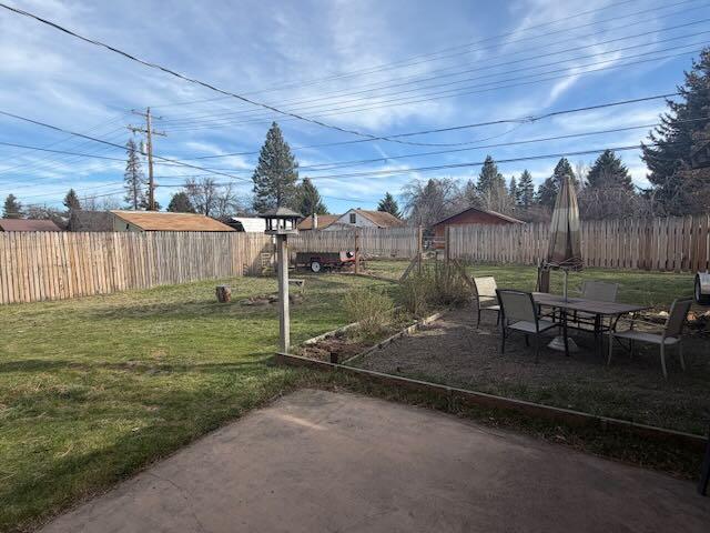 243 West Adams Avenue Sisters, OR 97759 - Photo 3 of 19 a backyard of a house with table and chairs