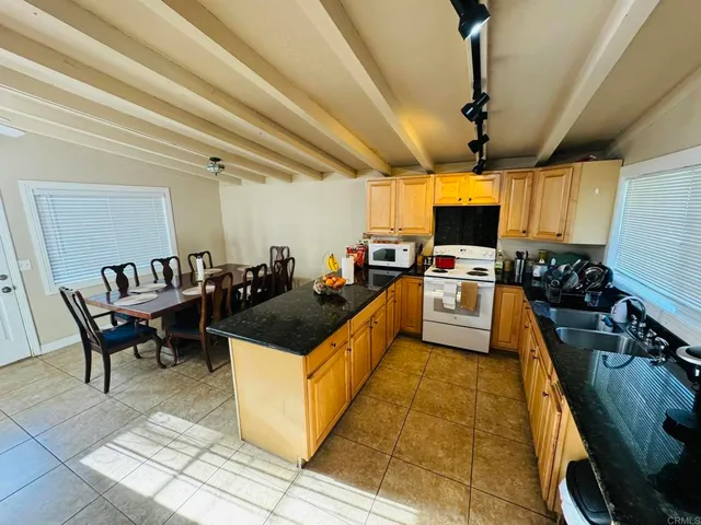 a kitchen with a sink and a stove top oven
