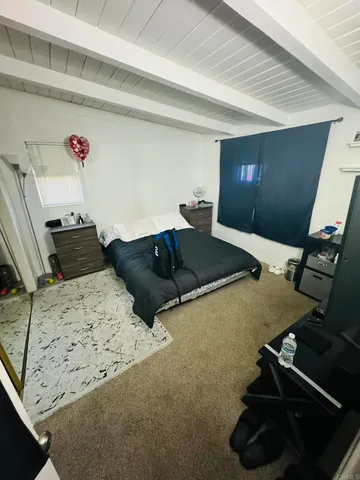 a bedroom with a bed and a window