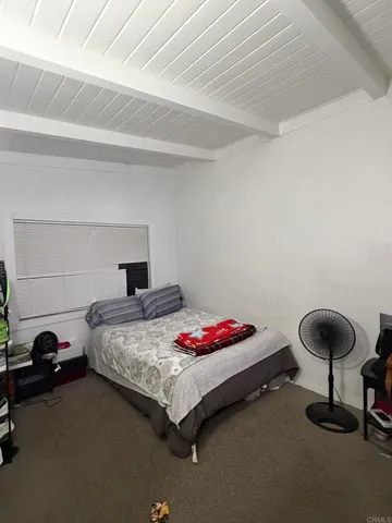 a bedroom with a bed and a ceiling fan