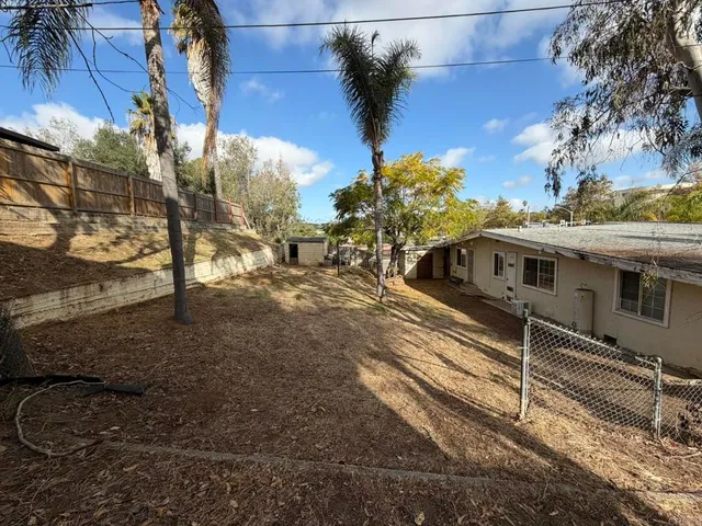 a living room with couches and kitchen view