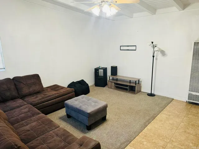 a large white kitchen with a large window