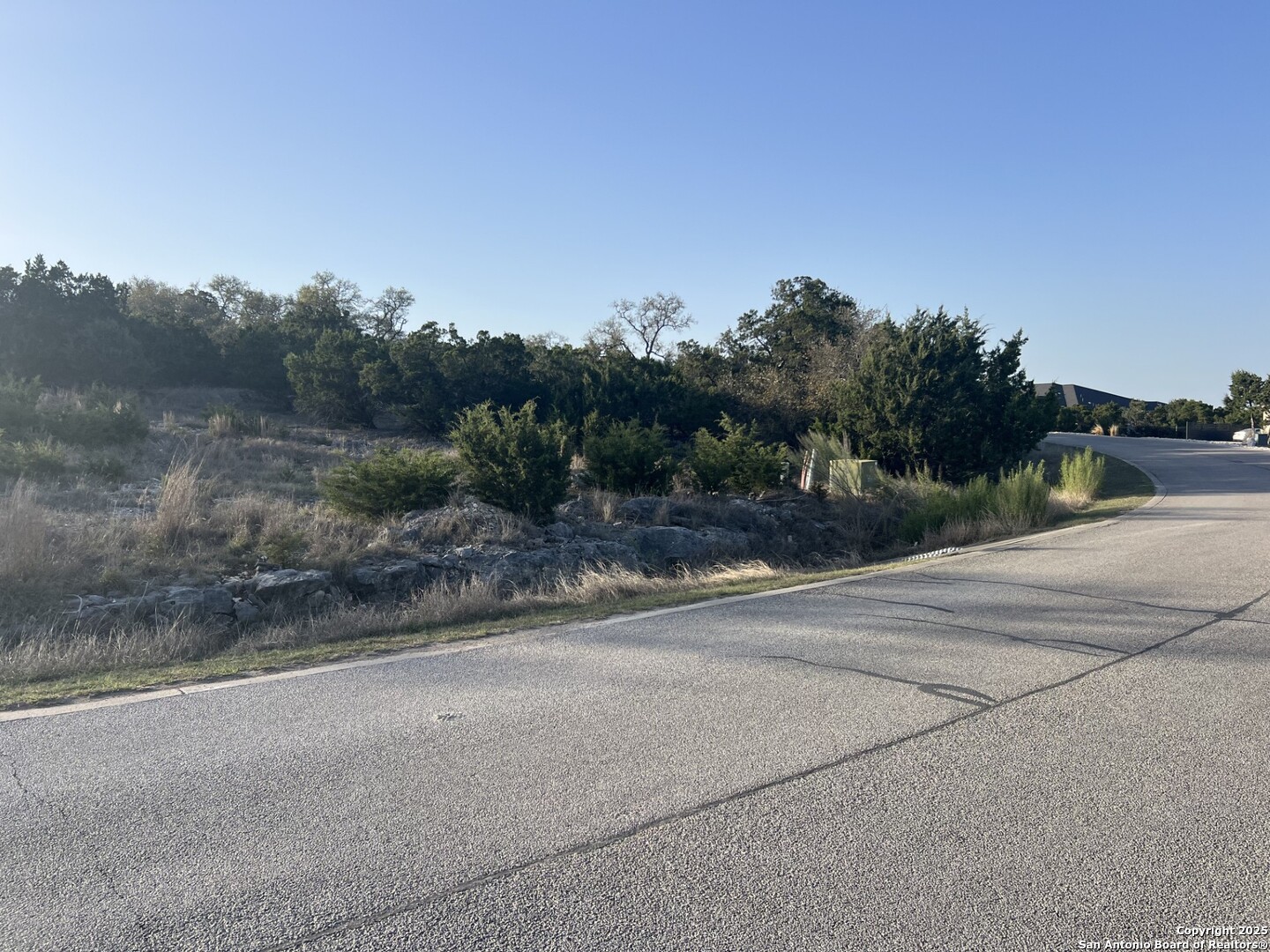 27407 Sunset Loop San Antonio, TX 78266 - Photo 22 of 36 a view of a road with a building in the background