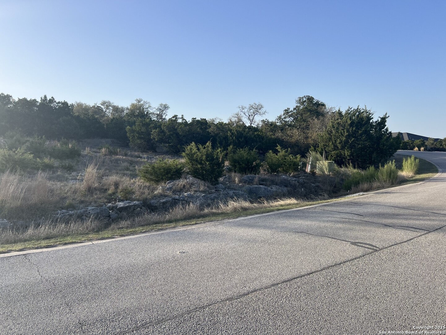 27407 Sunset Loop San Antonio, TX 78266 - Photo 23 of 36 a view of a road with a building in the background