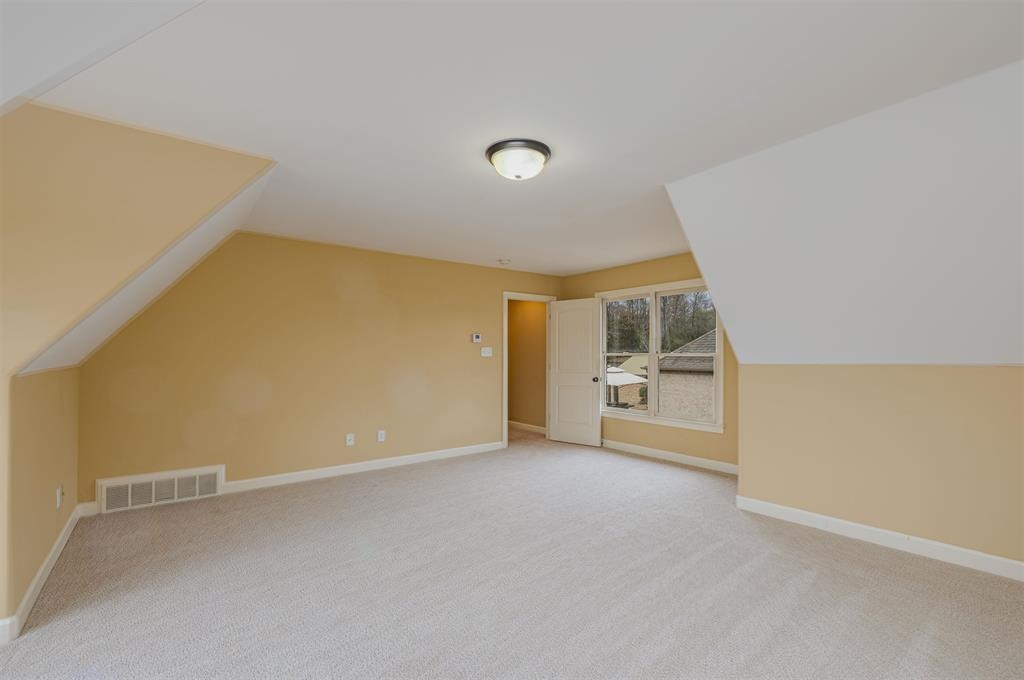 5380 Scarlet Ridge Drive Arlington, TN 38002 - Photo 22 of 35 Carpeted room with sloped ceilings, a flush-mount ceiling light, and a window with exterior views