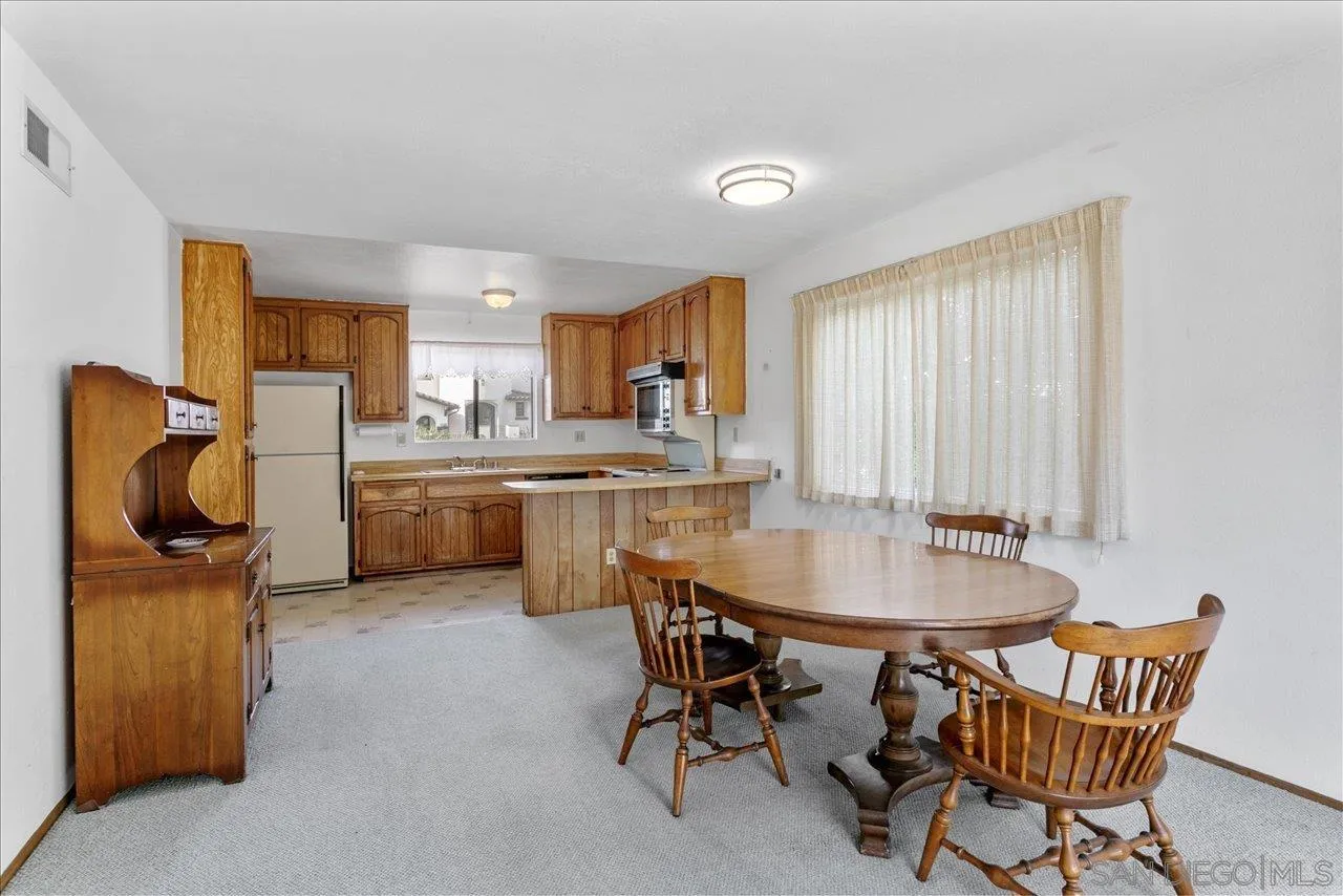 1221 Virginia Way La Jolla, CA 92037 - Photo 12 of 27 a dining room with furniture and window