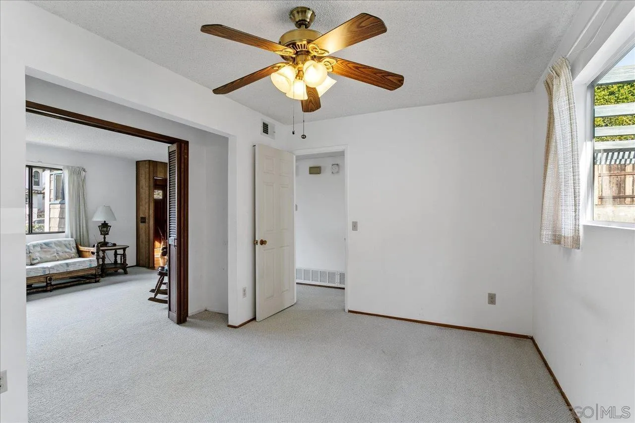 1221 Virginia Way La Jolla, CA 92037 - Photo 13 of 27 a view of a livingroom with a ceiling fan and a window