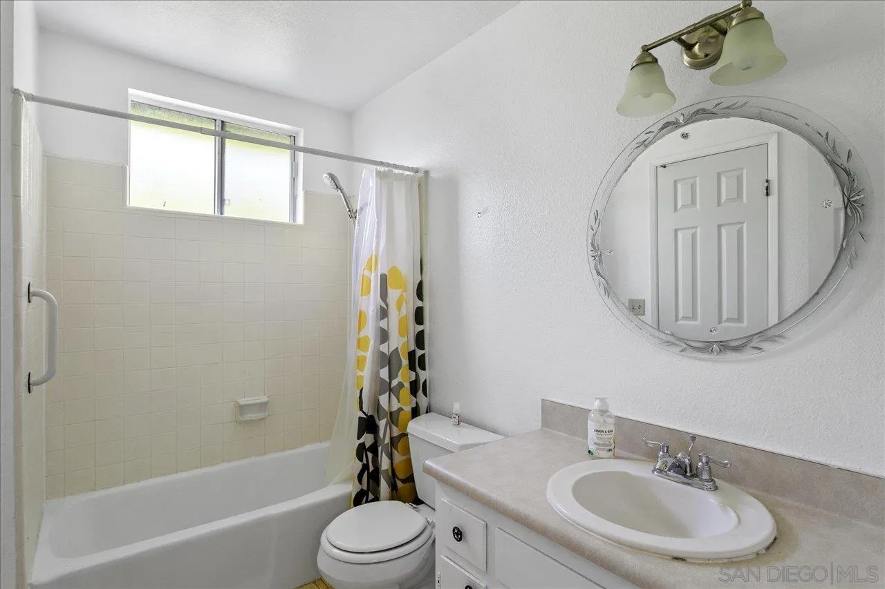 1221 Virginia Way La Jolla, CA 92037 - Photo 17 of 27 a bathroom with a sink a toilet and a tub