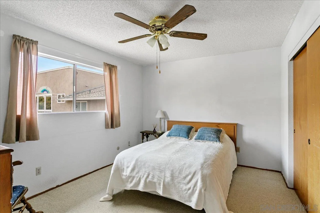 1221 Virginia Way La Jolla, CA 92037 - Photo 18 of 27 a bedroom with a bed and window