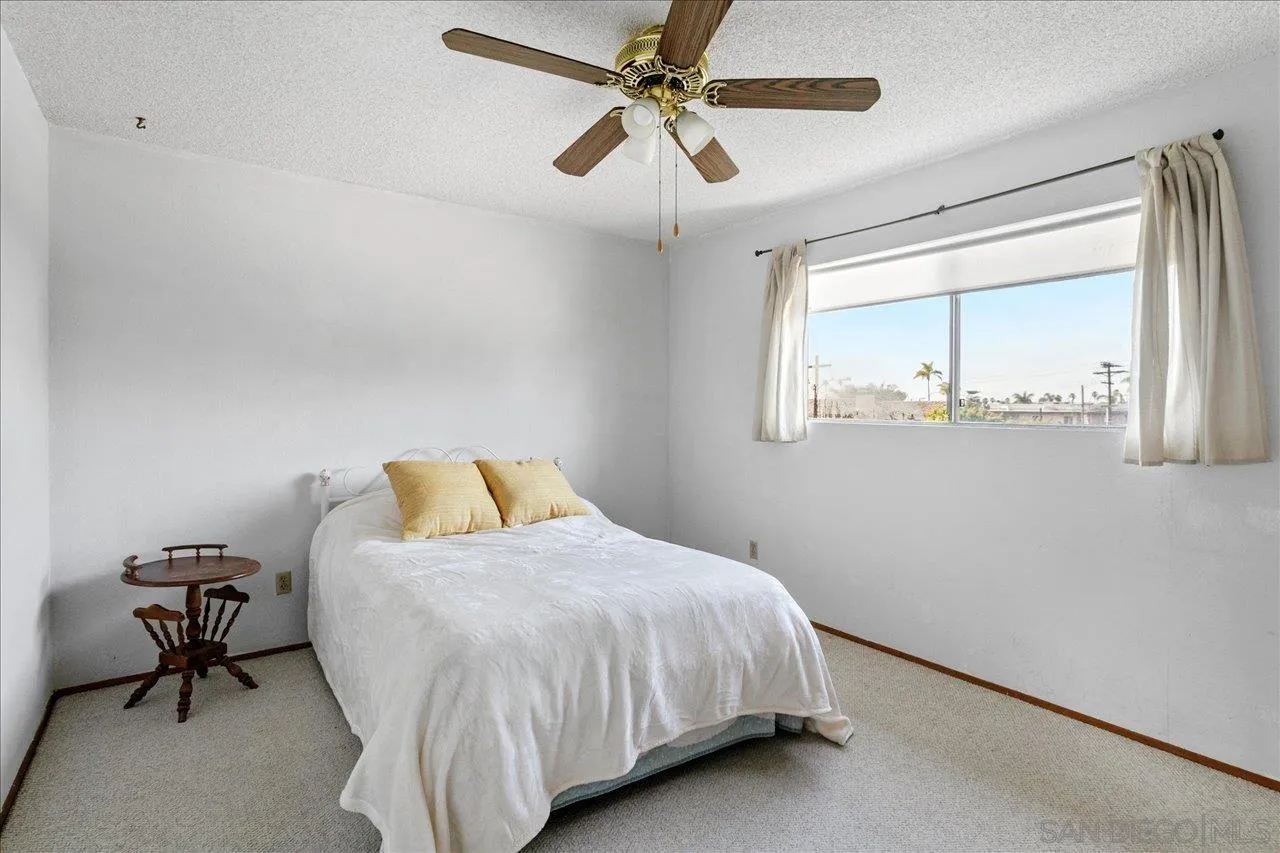 1221 Virginia Way La Jolla, CA 92037 - Photo 20 of 27 a bedroom with a bed a table and chair