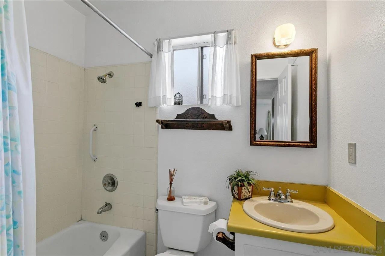 1221 Virginia Way La Jolla, CA 92037 - Photo 22 of 27 a bathroom with a sink toilet and shower