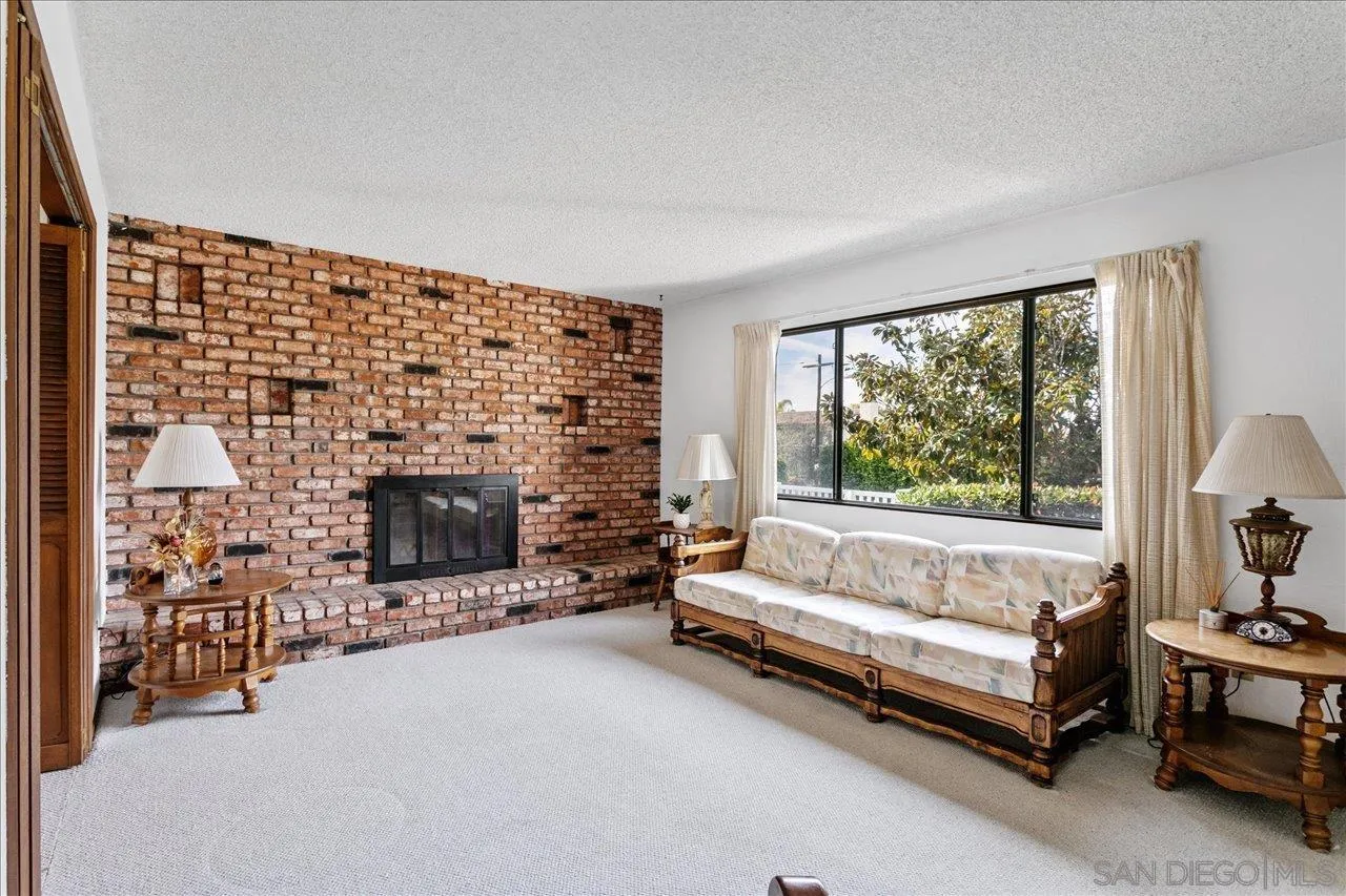 1221 Virginia Way La Jolla, CA 92037 - Photo 6 of 27 a living room with furniture and a fireplace