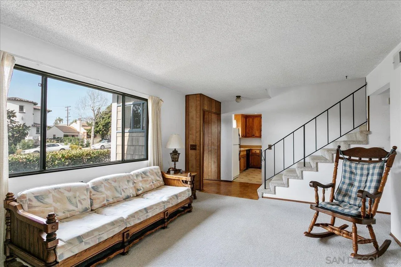 1221 Virginia Way La Jolla, CA 92037 - Photo 7 of 27 a living room with furniture and a large window
