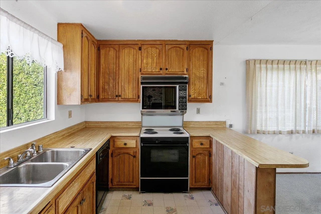 1221 Virginia Way La Jolla, CA 92037 - Photo 9 of 27 a kitchen with a sink stove and cabinets