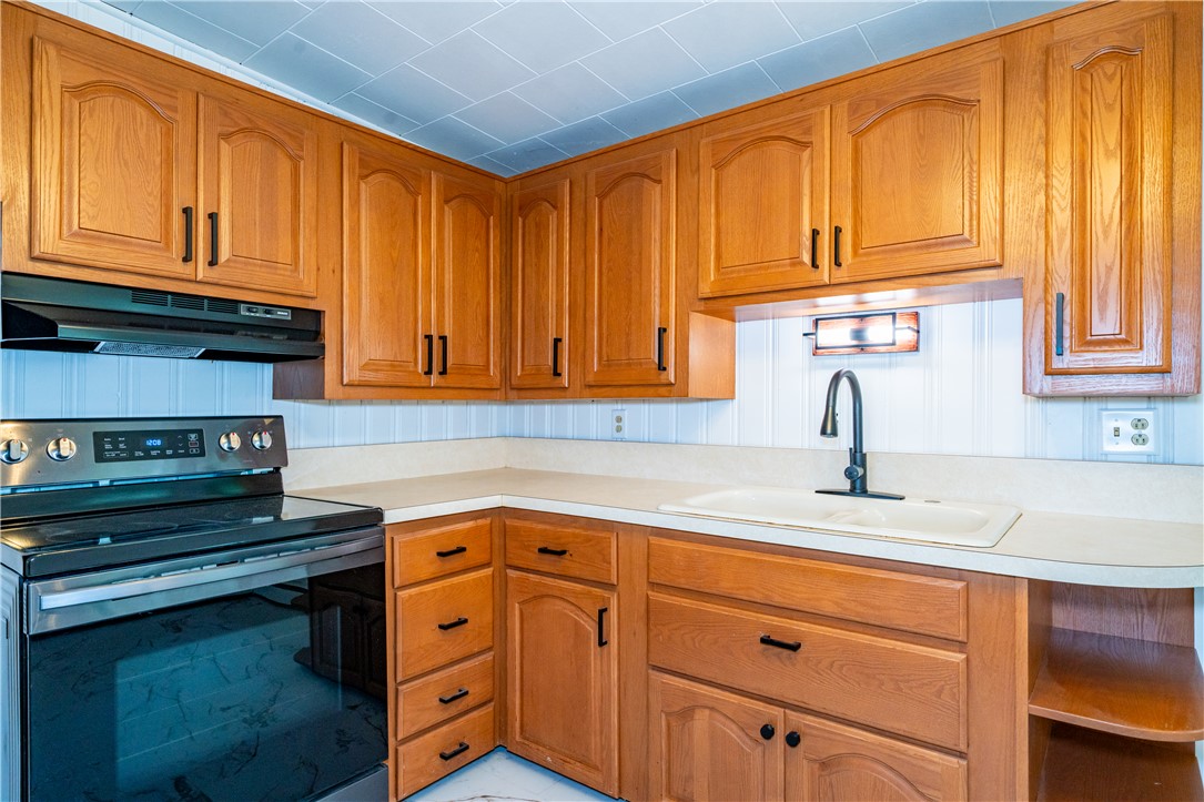 11296 Pansing Road Brookville, OH 45309 - Photo 11 of 53 This kitchen offers a practical layout with classic cabinetry and functional appliances.