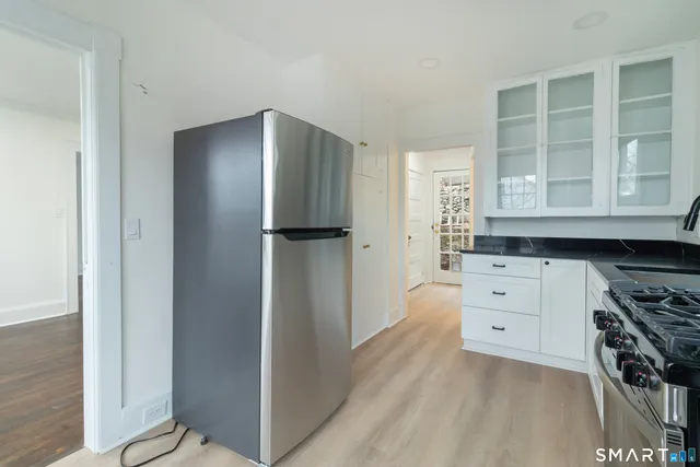 a kitchen with stainless steel appliances a refrigerator and cabinets