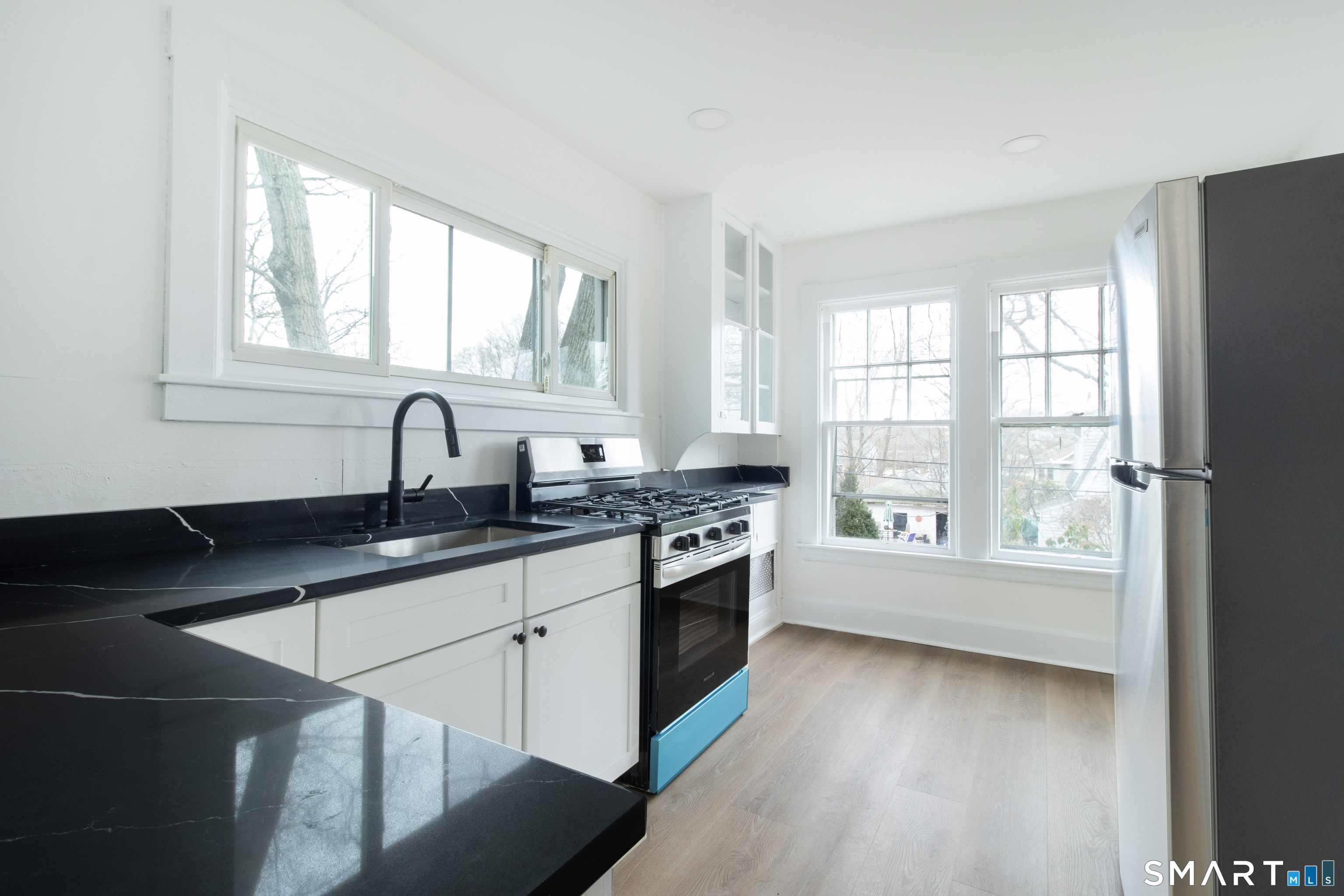 33 Julian Terrace Norwich, CT 06360 - Photo 26 of 36 a kitchen with granite countertop a stove a sink and a window