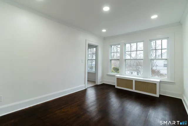 an empty room with wooden floor