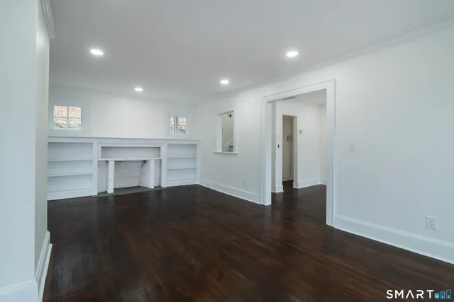 a living room with furniture a fireplace and a large mirror