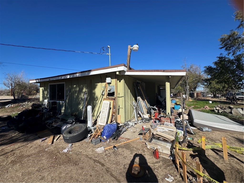 10175 Valle Vista Road Phelan, CA 92371 - Photo 14 of 27 a view of a patio with table and chairs a barbeque grill and a small yard