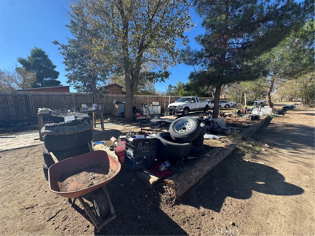 10175 Valle Vista Road Phelan, CA 92371 - Photo 20 of 27 a view of a backyard with table and chairs potted plants and a patio