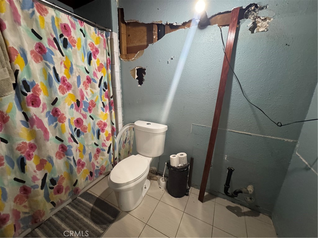 10175 Valle Vista Road Phelan, CA 92371 - Photo 5 of 27 a white toilet sitting next to a shower curtain