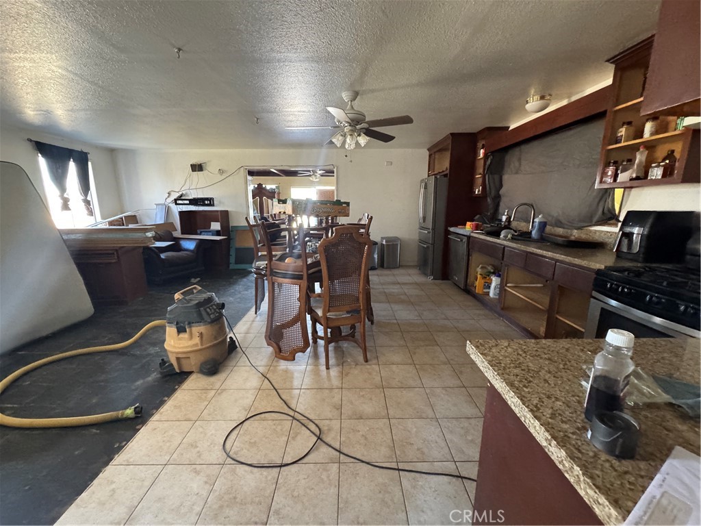 10175 Valle Vista Road Phelan, CA 92371 - Photo 6 of 27 a kitchen with lots of counter top space and dining table