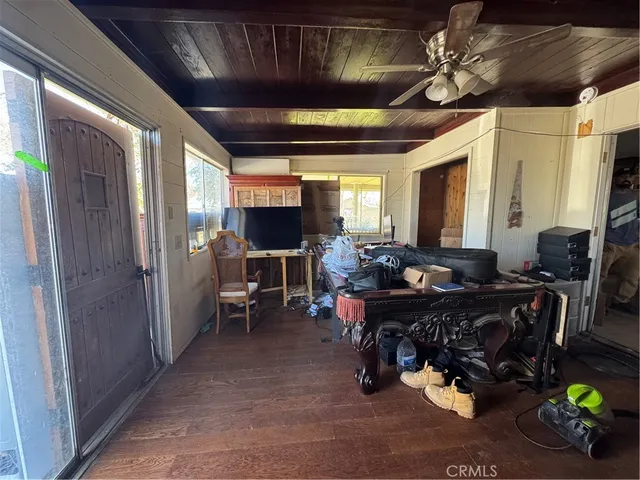 a view of a livingroom with workspace and a window