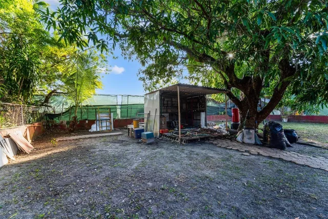 a view of a house with a porch and a tree