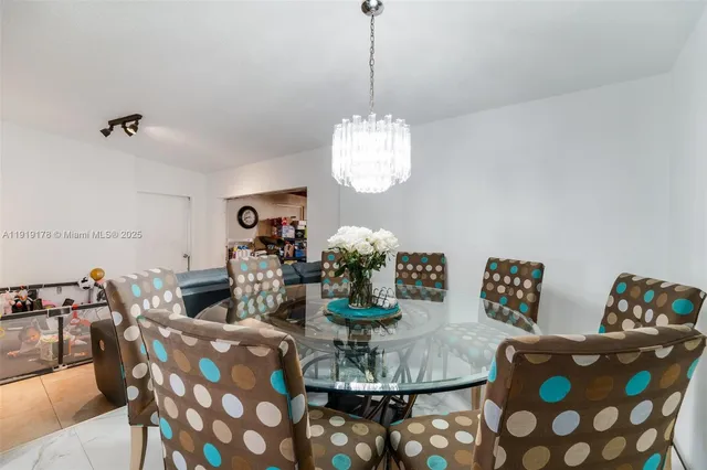 a dining room with furniture and a chandelier