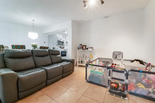 a living room with furniture and a dresser