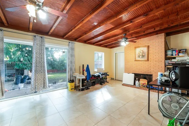 a living room with furniture gym equipment and a large window