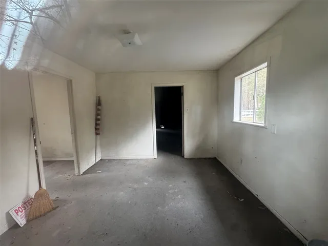 a wooden house with trees in the background