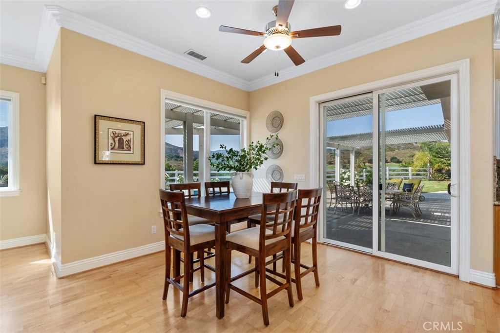 23505 Carancho Road Temecula, CA 92590 - Photo 17 of 73 a view of a dining room with furniture window and wooden floor