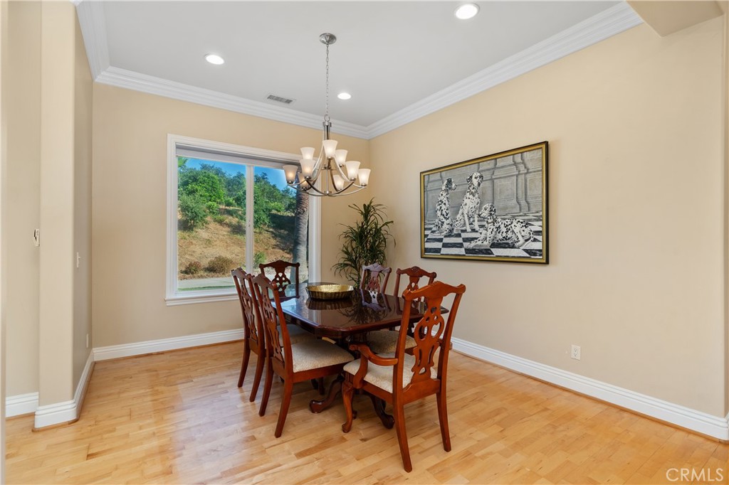23505 Carancho Road Temecula, CA 92590 - Photo 18 of 73 a dining room with furniture a window and a chandelier