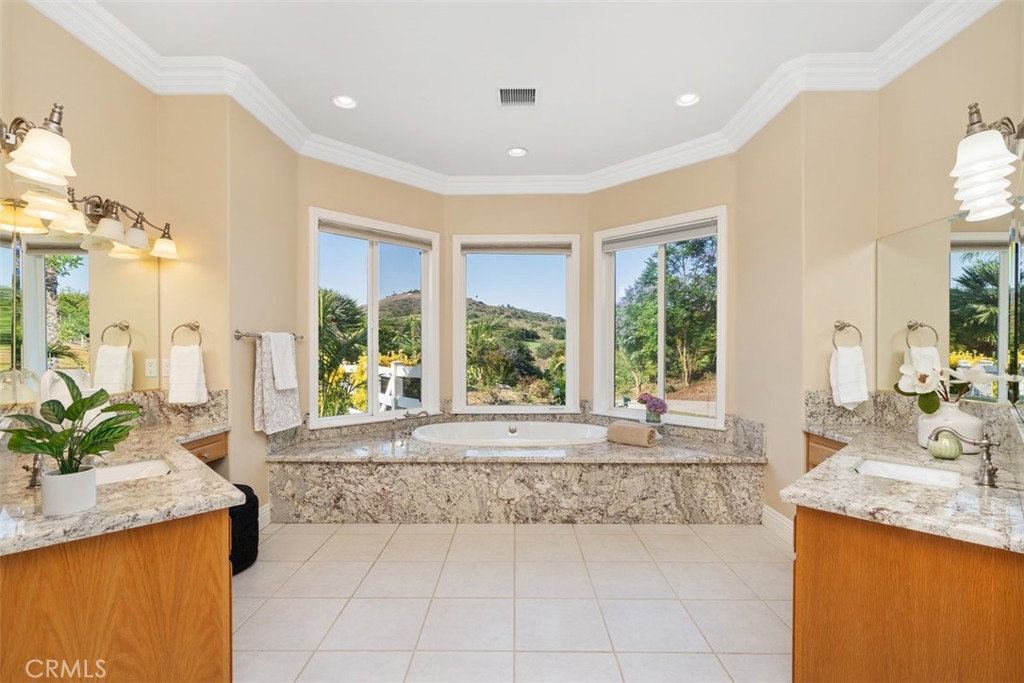 23505 Carancho Road Temecula, CA 92590 - Photo 24 of 73 a large white kitchen with a large window and stainless steel appliances