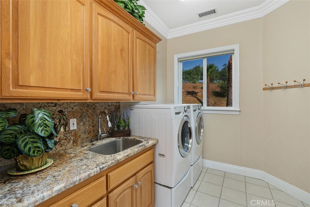 23505 Carancho Road Temecula, CA 92590 - Photo 33 of 73 a kitchen with a sink a stove and cabinets