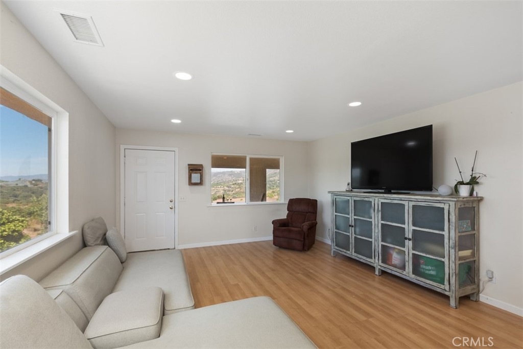 23505 Carancho Road Temecula, CA 92590 - Photo 52 of 73 a living room with furniture and a flat screen tv